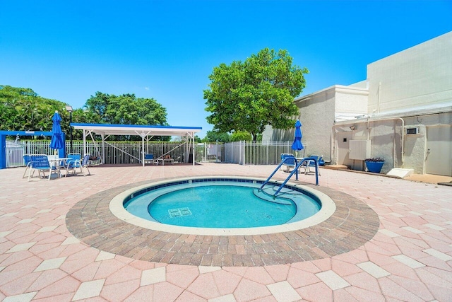 view of pool featuring a swimming pool, fence, and a patio