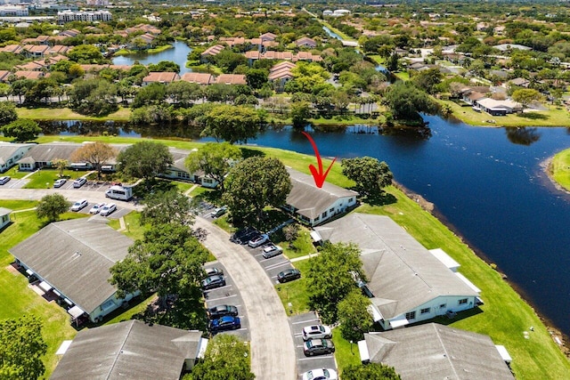 drone / aerial view featuring a water view and a residential view