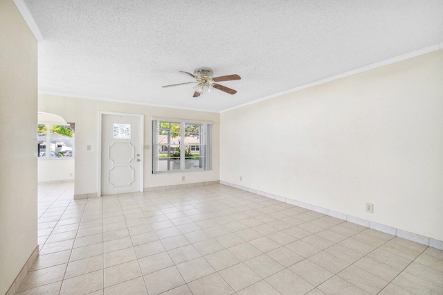 spare room featuring a textured ceiling, ceiling fan, and ornamental molding