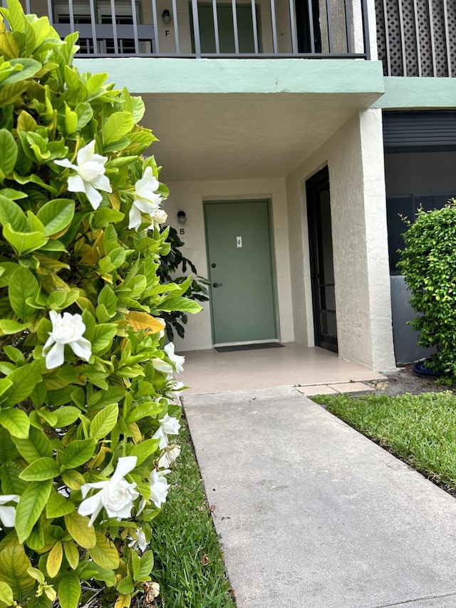 doorway to property with stucco siding