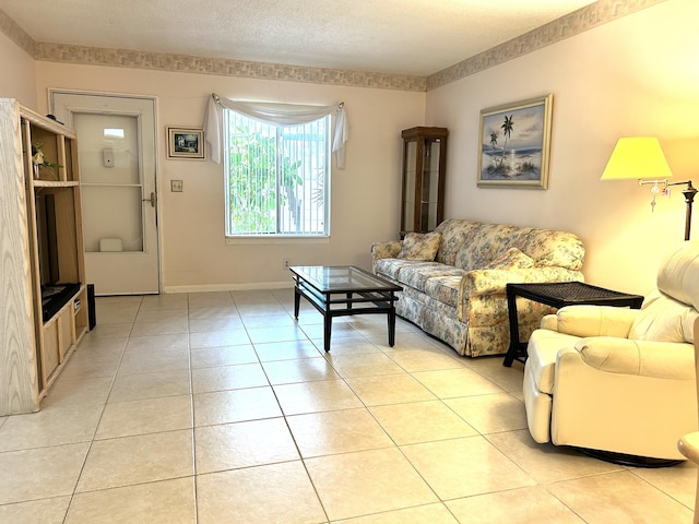 living area with baseboards and light tile patterned flooring