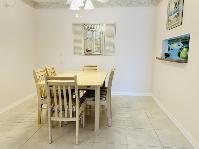 dining space featuring light tile patterned floors, baseboards, and ceiling fan
