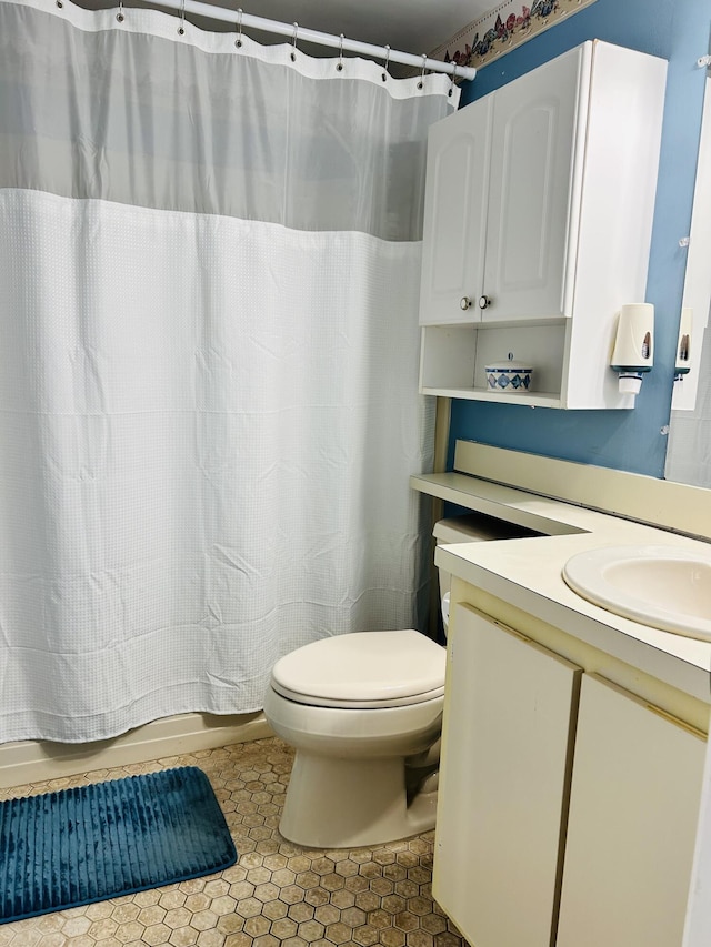 full bathroom with toilet, tile patterned floors, vanity, and a shower with shower curtain