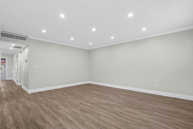 116 Seville D, Delray Beach, FL 33446 - unfurnished room featuring crown molding, visible vents, baseboards, and wood finished floors