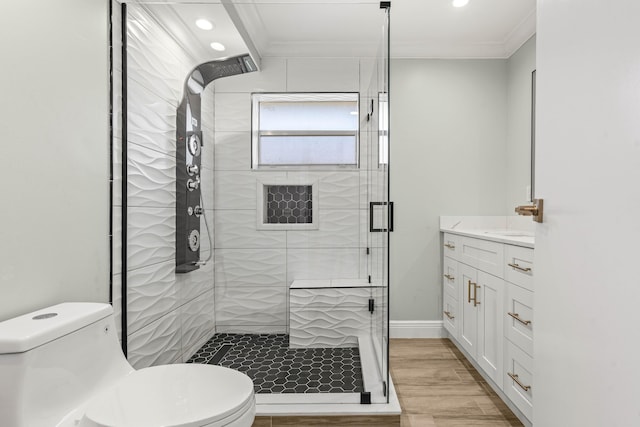 116 Seville D, Delray Beach, FL 33446 - full bathroom featuring ornamental molding, toilet, a shower stall, vanity, and wood finished floors