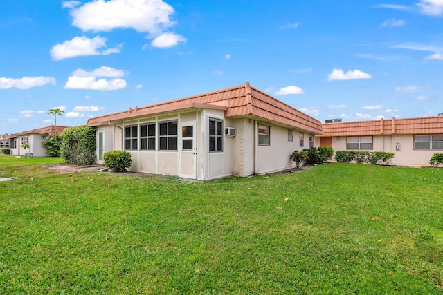 116 Seville D, Delray Beach, FL 33446 - back of property with a yard, stucco siding, and mansard roof