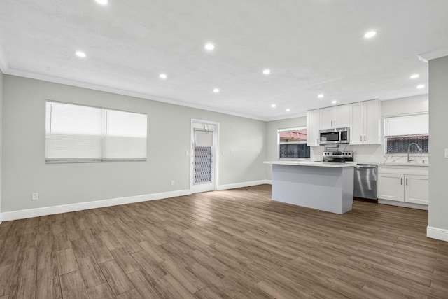 116 Seville D, Delray Beach, FL 33446 - kitchen featuring ornamental molding, recessed lighting, a kitchen island, stainless steel appliances, and a sink