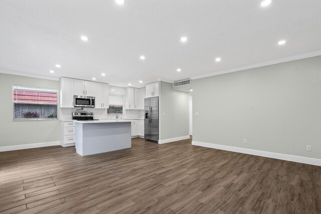116 Seville D, Delray Beach, FL 33446 - kitchen with baseboards, ornamental molding, open floor plan, white cabinets, and appliances with stainless steel finishes