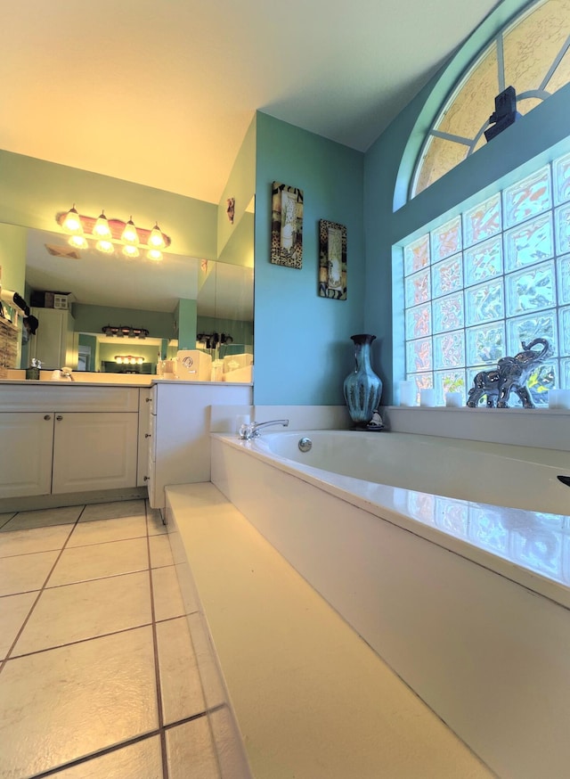 bathroom with tile patterned floors, vanity, and a bath