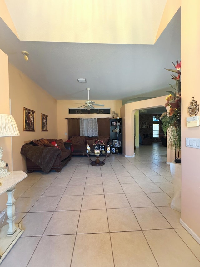 living room with light tile patterned floors, a ceiling fan, and visible vents