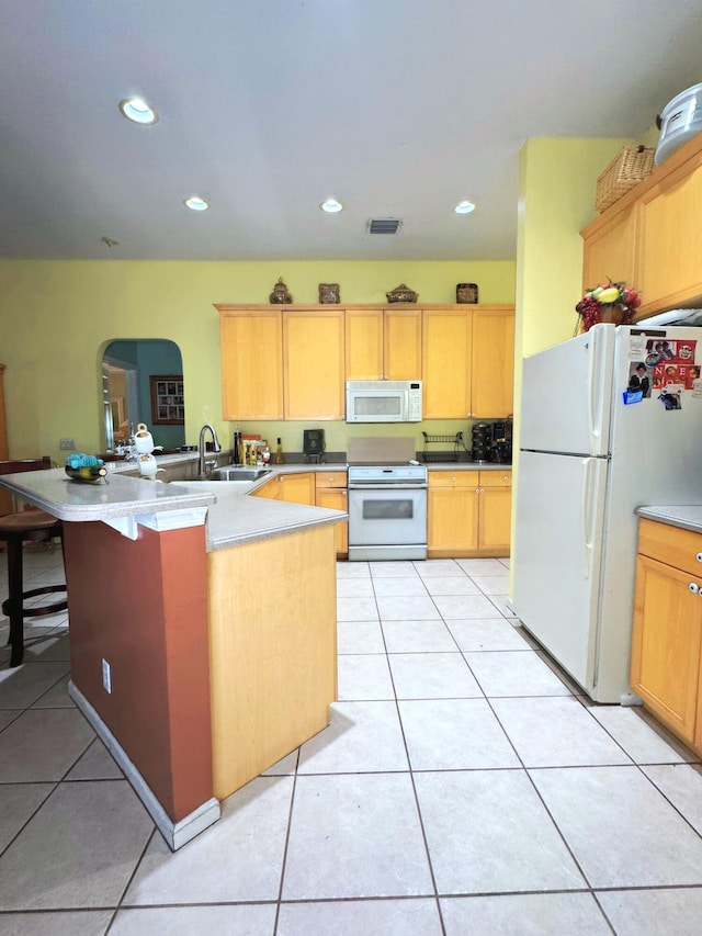 kitchen featuring visible vents, light tile patterned floors, arched walkways, white appliances, and a peninsula