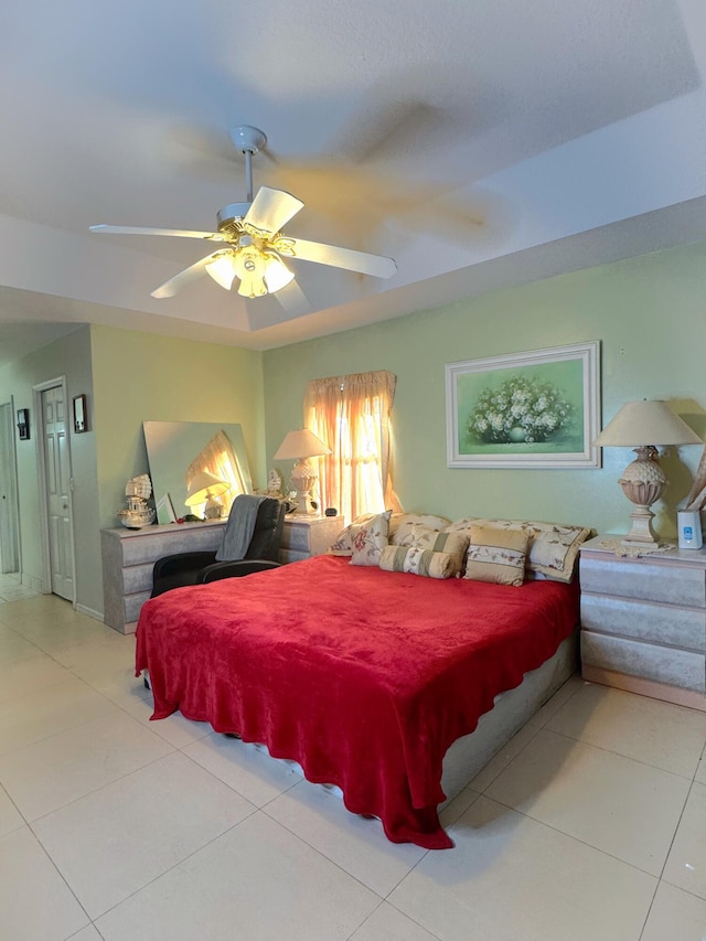 tiled bedroom featuring a ceiling fan