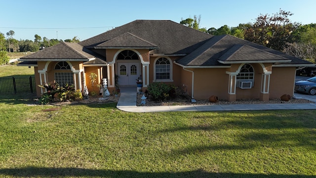 ranch-style home with a front lawn, fence, cooling unit, and stucco siding
