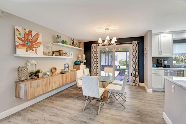 6122 Overland Pl, Delray Beach, FL 33484 - dining room with baseboards, light wood finished floors, and an inviting chandelier