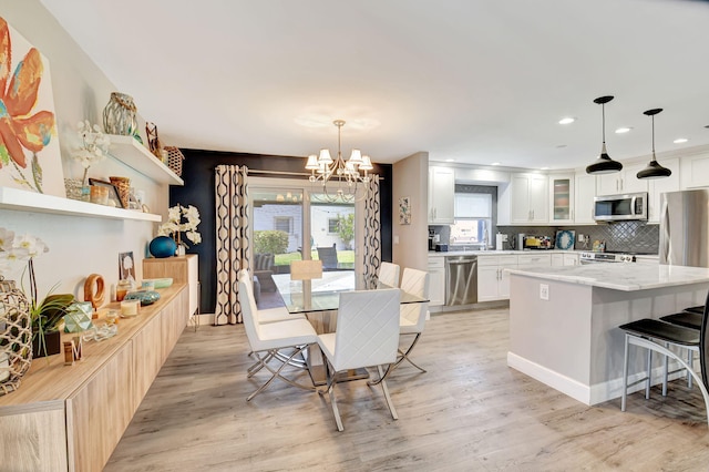 6122 Overland Pl, Delray Beach, FL 33484 - dining area with light wood-style flooring, a notable chandelier, and recessed lighting