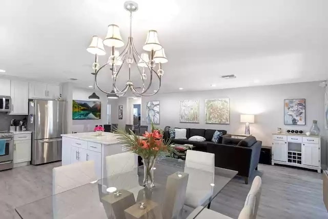 6122 Overland Pl, Delray Beach, FL 33484 - dining area featuring recessed lighting, light wood-style flooring, visible vents, and a notable chandelier