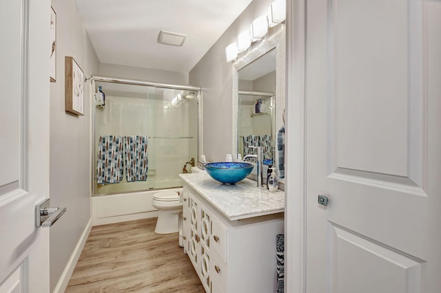 6122 Overland Pl, Delray Beach, FL 33484 - bathroom featuring shower / bath combination with glass door, vanity, baseboards, toilet, and wood finished floors