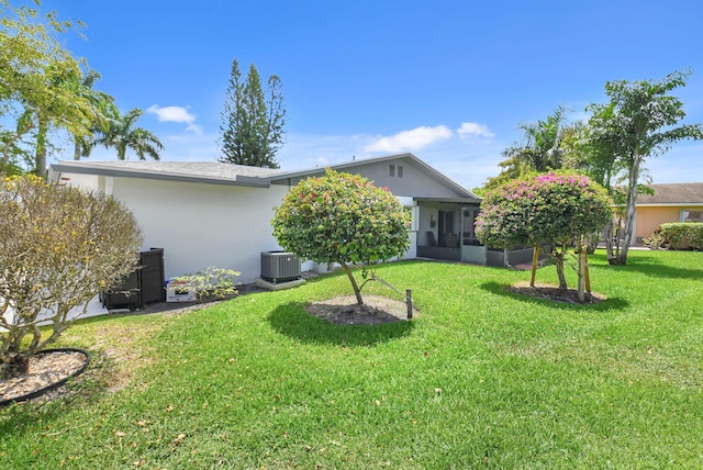 6122 Overland Pl, Delray Beach, FL 33484 - rear view of property featuring cooling unit, a yard, and stucco siding