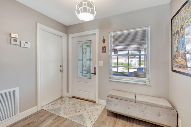 6122 Overland Pl, Delray Beach, FL 33484 - doorway to outside featuring visible vents, baseboards, and wood finished floors