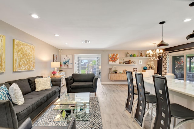 6122 Overland Pl, Delray Beach, FL 33484 - living room with a chandelier, recessed lighting, visible vents, and light wood-style flooring