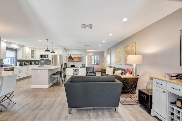 6122 Overland Pl, Delray Beach, FL 33484 - living room featuring visible vents, light wood-type flooring, and recessed lighting