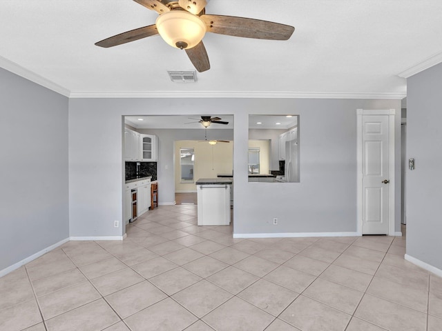 unfurnished living room featuring visible vents, a ceiling fan, ornamental molding, light tile patterned floors, and baseboards