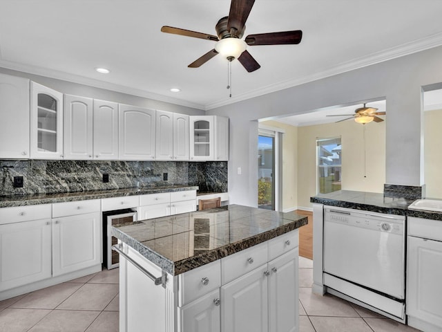 kitchen featuring wine cooler, decorative backsplash, white dishwasher, a ceiling fan, and tile countertops