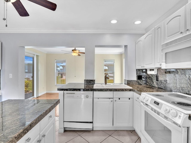 kitchen with a ceiling fan, a sink, white appliances, a wealth of natural light, and white cabinets