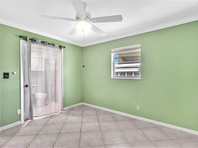 empty room featuring baseboards, tile patterned floors, a ceiling fan, and ornamental molding
