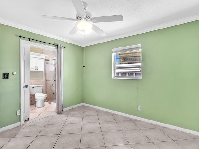 unfurnished room featuring ornamental molding, baseboards, light tile patterned flooring, and ceiling fan