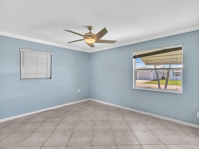 tiled spare room with crown molding, baseboards, and ceiling fan