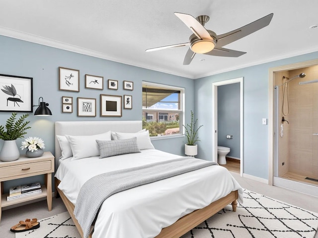 bedroom with light carpet, baseboards, a ceiling fan, ensuite bath, and ornamental molding
