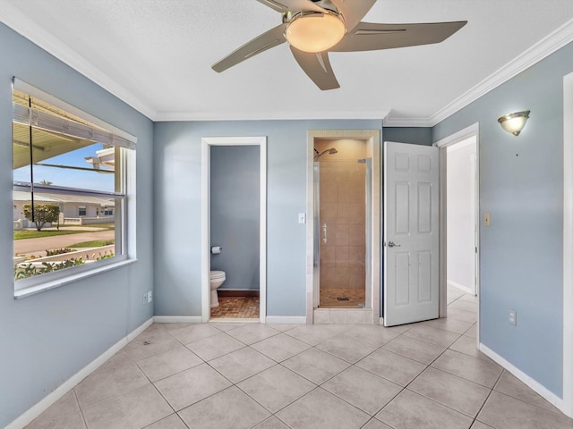 unfurnished bedroom featuring baseboards, connected bathroom, light tile patterned floors, and crown molding