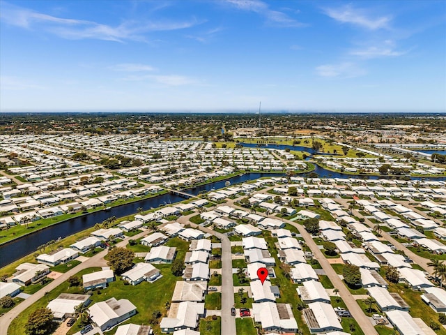 drone / aerial view featuring a water view and a residential view