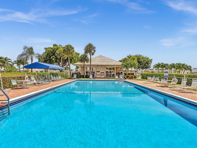 pool featuring fence and a patio