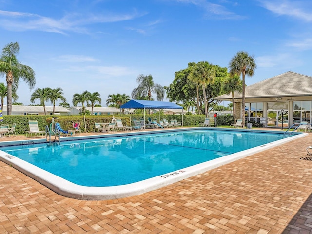 community pool featuring a patio area and fence