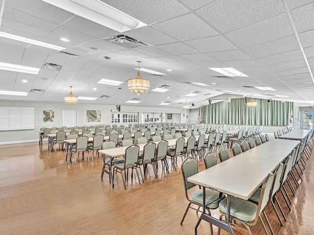 dining room featuring baseboards, wood finished floors, and visible vents