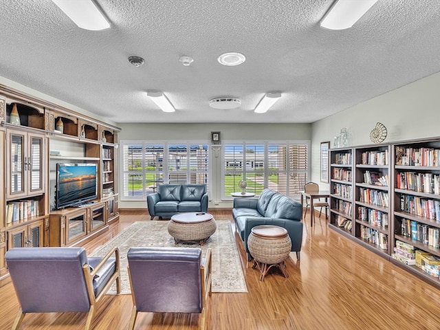 living room with wood finished floors and a textured ceiling