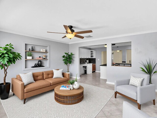 living area with visible vents, ceiling fan, ornamental molding, and light tile patterned floors