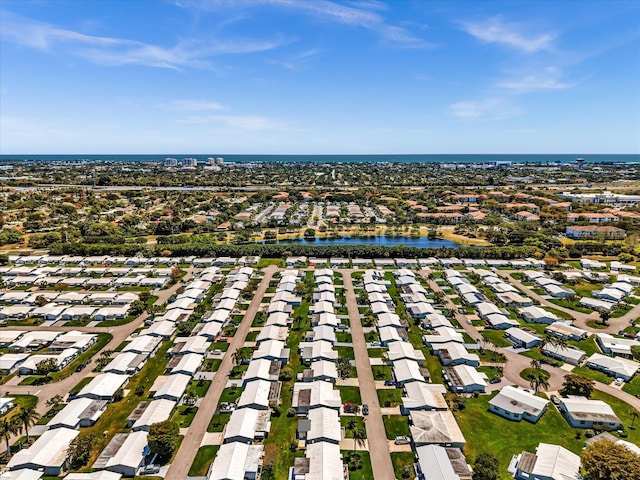 drone / aerial view with a residential view and a water view