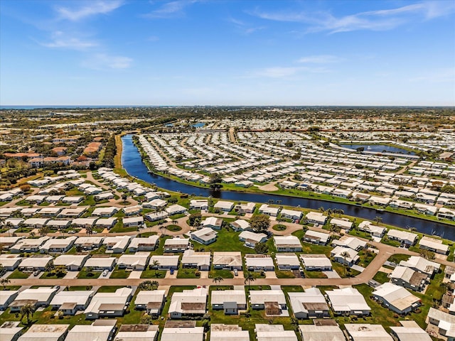 drone / aerial view with a water view and a residential view