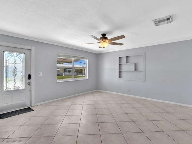 foyer with a textured ceiling, light tile patterned floors, ceiling fan, baseboards, and visible vents