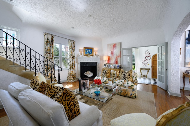 359 E Lakewood Rd, West Palm Beach, FL 33405 - living area with a textured ceiling, wood finished floors, and stairway