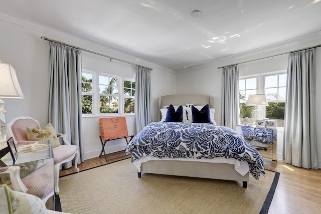 359 E Lakewood Rd, West Palm Beach, FL 33405 - bedroom with ornamental molding, multiple windows, and light wood-style floors