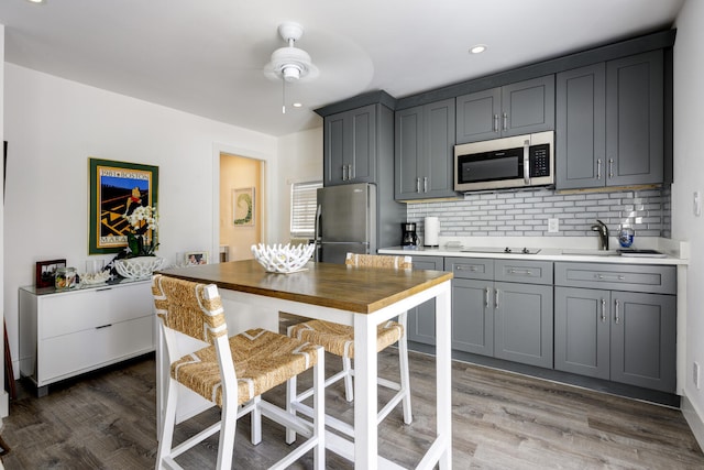 359 E Lakewood Rd, West Palm Beach, FL 33405 - kitchen featuring wood finished floors, ceiling fan, a sink, and stainless steel appliances