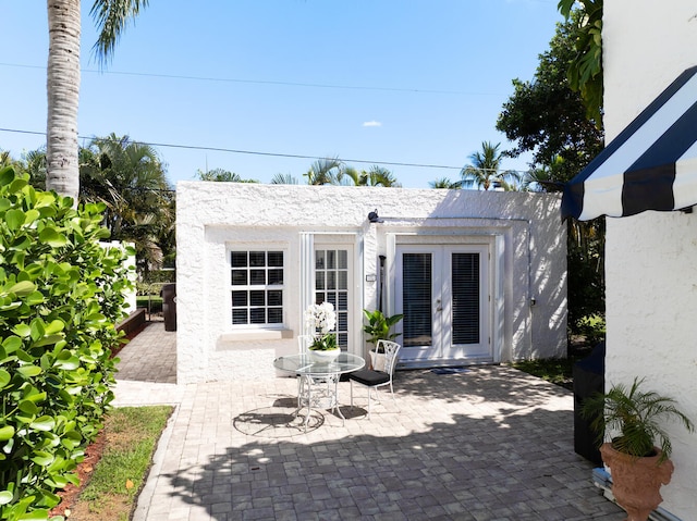359 E Lakewood Rd, West Palm Beach, FL 33405 - view of patio / terrace featuring an outbuilding and french doors
