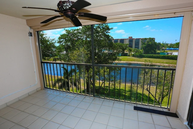 balcony with a water view and ceiling fan