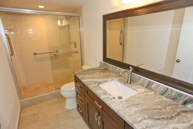 bathroom featuring tile patterned flooring, a stall shower, vanity, toilet, and recessed lighting