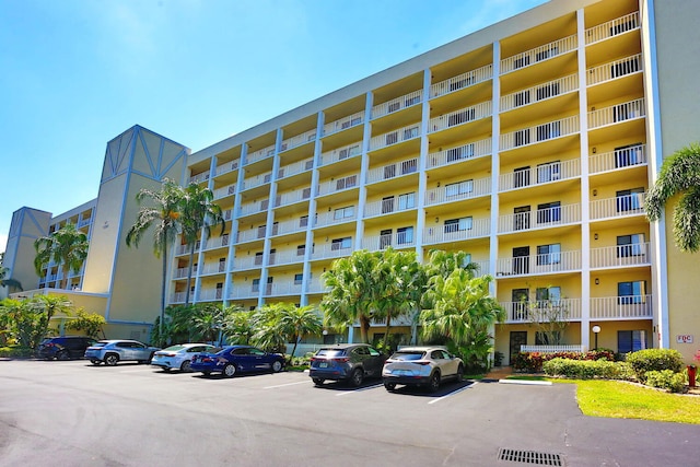 view of building exterior featuring uncovered parking
