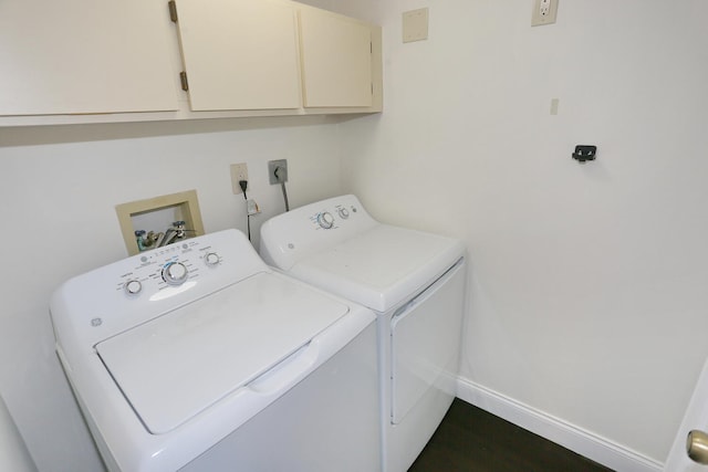 laundry area with cabinet space, independent washer and dryer, and baseboards